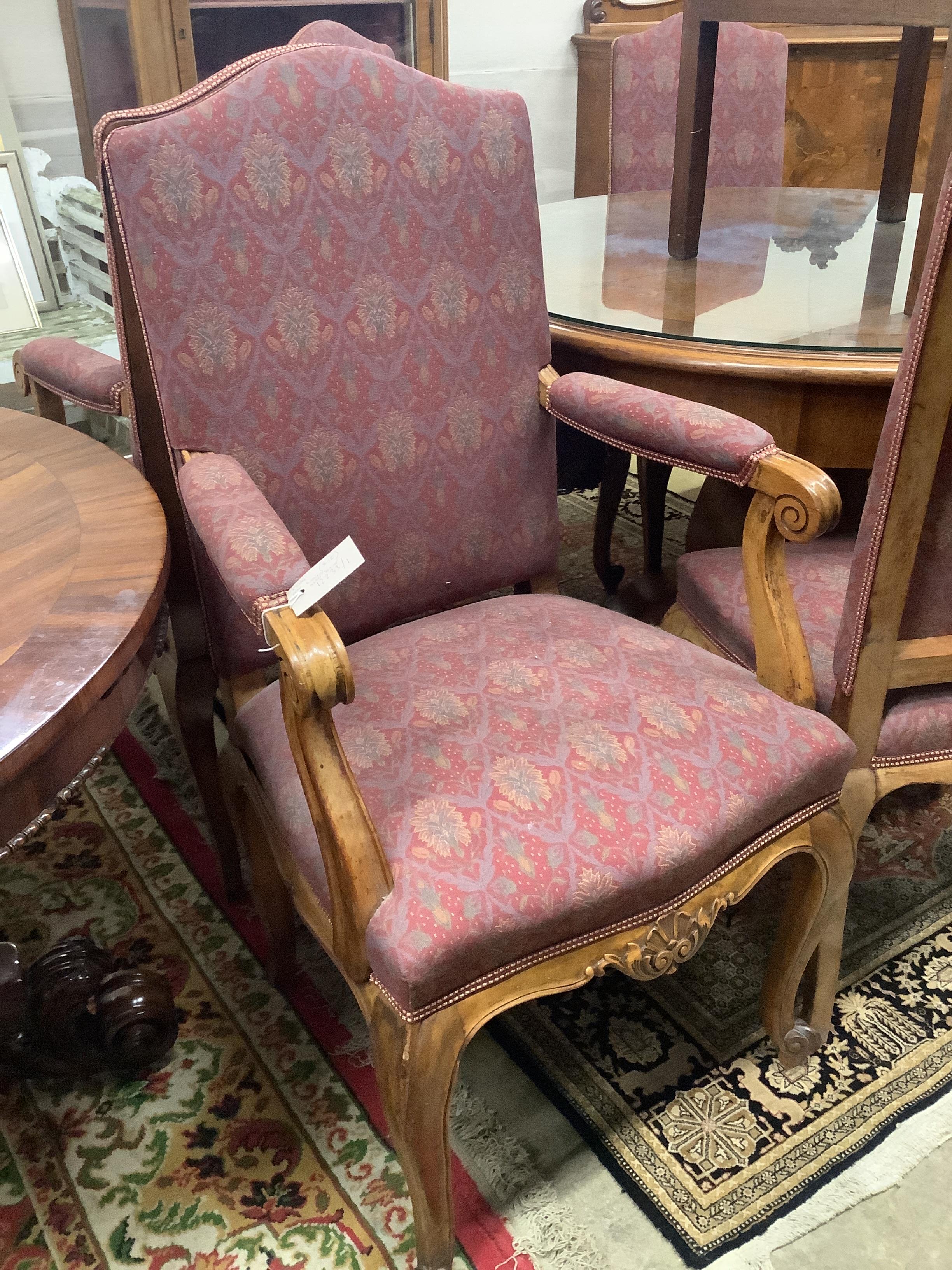 An Austrian marquetry inlaid circular walnut dining table, diameter 114cm, height 79cm, together with eight upholstered dining chairs on cabriole legs